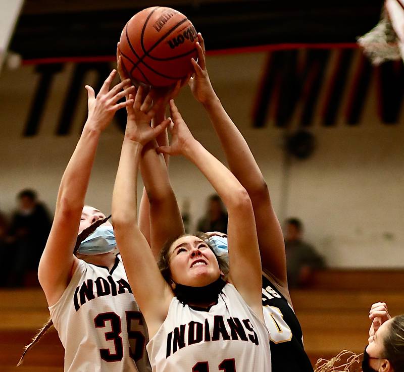Minooka's Kinzie Caves (11) and Ashley Currier battle for a rebound Saturday during a 38-33 loss to Hinsdale South.