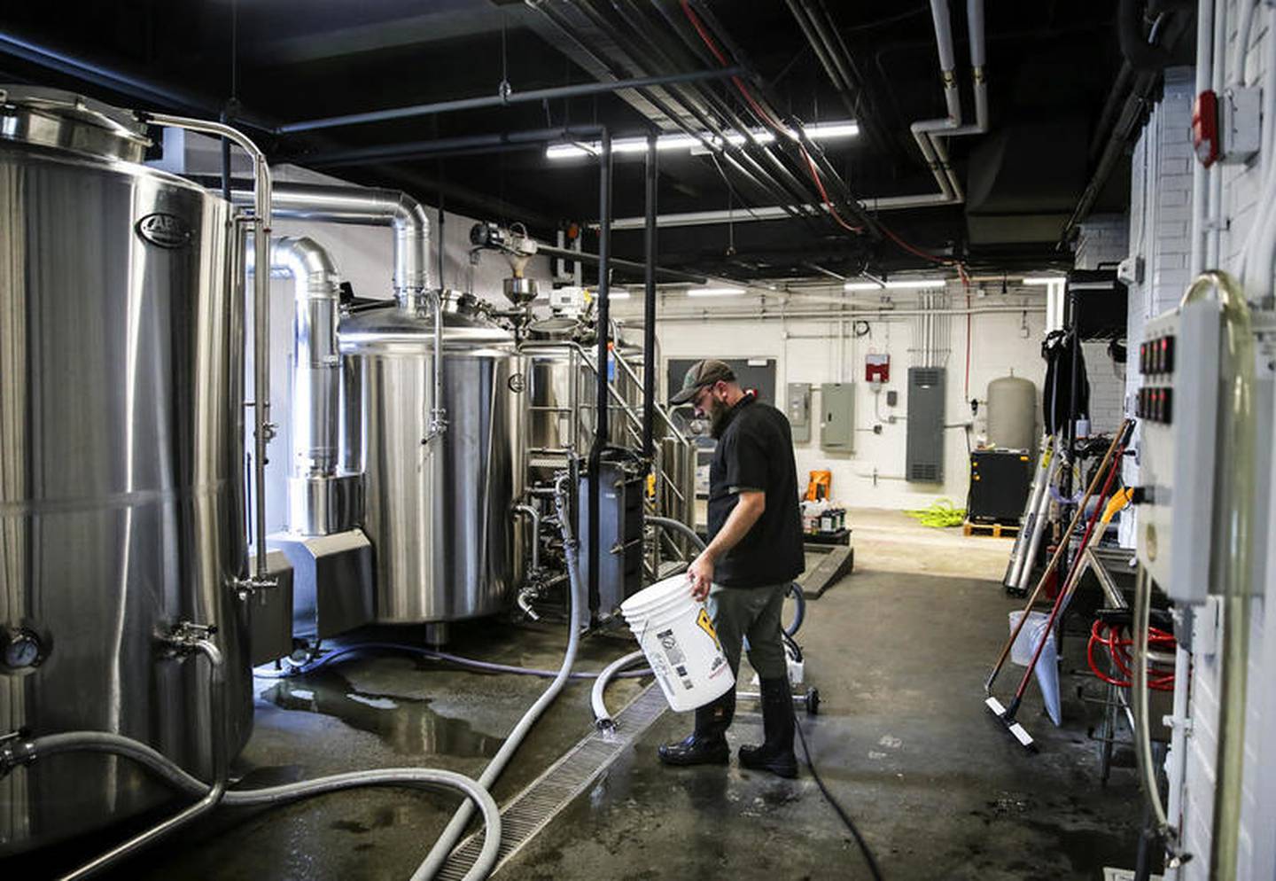 Dan Rosenberg, head brewer at MyGrain Brewing, cleans several brewing tanks, Sept. 6, 2017 Wednesday at MyGrain Brewing Co. in Joliet.