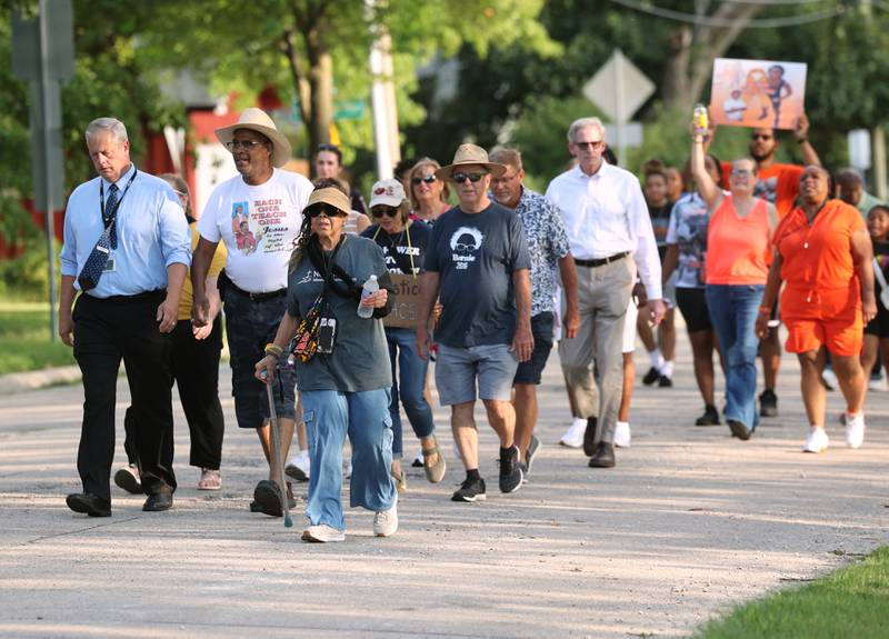 Marchers make their way through the route Friday, July 18, 2025, during the DeKalb Peace Walk and Rally. The event, which featured a march, food vendors and music, was held to encourage the community to work together against gun violence.