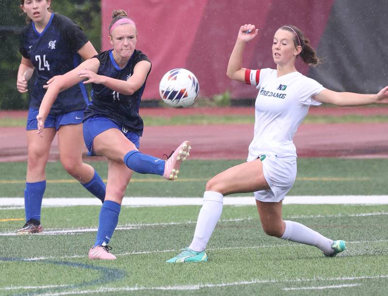 Burlington Central's Kendall Grigg (left) licks the ball away from Peoria Notre Dame's Rylie Bare during their third place game Saturday, June 1, 2024, at the IHSA Class 2A state soccer finals at North Central College in Naperville.