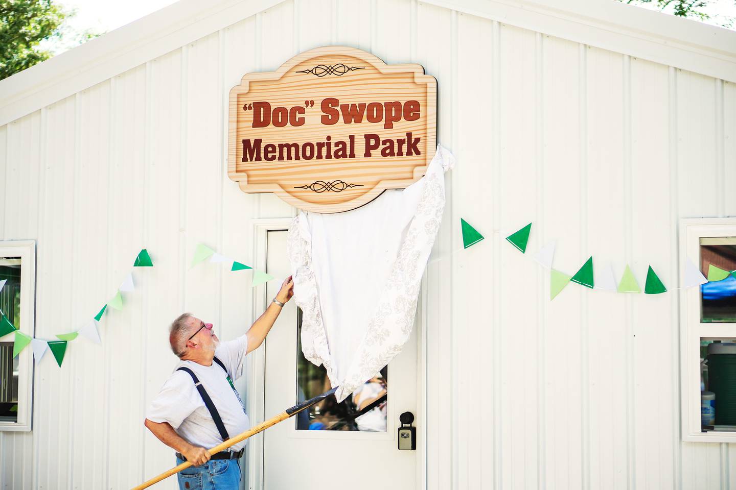 Compton held celebrations of its 150th anniversary – its sesquicentennial – on July 19-20 with a craft show, kids activities, bags tournament, time capsule arrangement, cake walk, a display of local history, Lions Club lunch and dinner, live music and the dedication of one of its parks to late village president Donald “Doc” Swope. Compton fire chief Steve Gilmore unveils the new park sign.