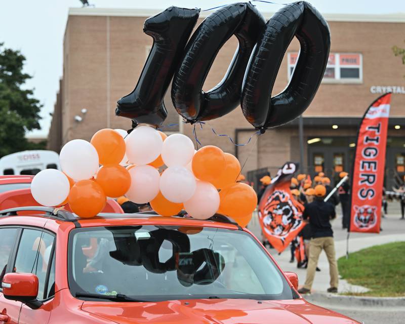 Balloons float above the lead start car for the Crystal Lake Central H.S. 100th anniversary homecoming day parade on a rainy Saturday, Sep. 16, 2023 in Crystal Lake. The parade began at the high school and made its way through downtown Crystal Lake.