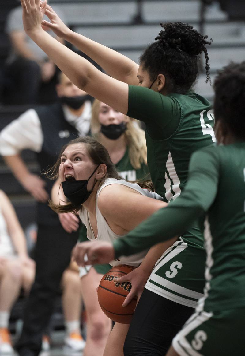 McHenry's Lynette Alsot looks for a shot with pressure from Crystal Lake South's Nicole Molgado during their game on Tuesday, January 11, 2022 in McHenry.