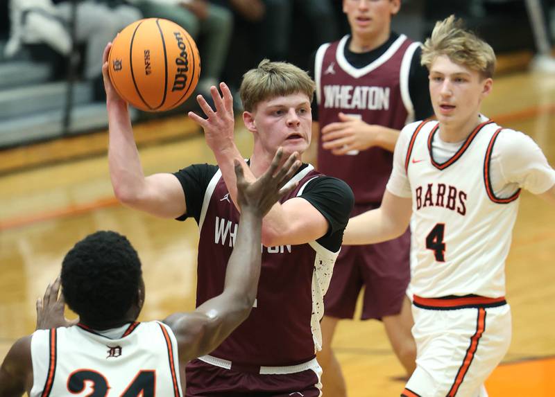 Wheaton Academy's Tyler Anderson looks to pass in front of DeKalb's Myles Newman during their game Wednesday, Jan. 14, 2026, at DeKalb High School.