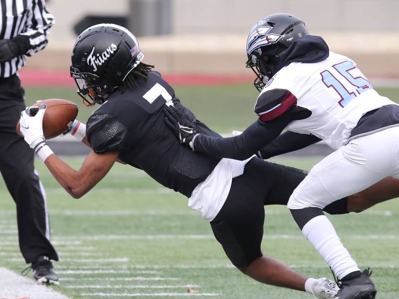 Fenwick's Eian Pugh makes a catch in front of Kankakee's Deleon King during the Class 5A state championship Saturday, Nov. 27, 2021, in Huskie Stadium at Northern Illinois University in DeKalb.