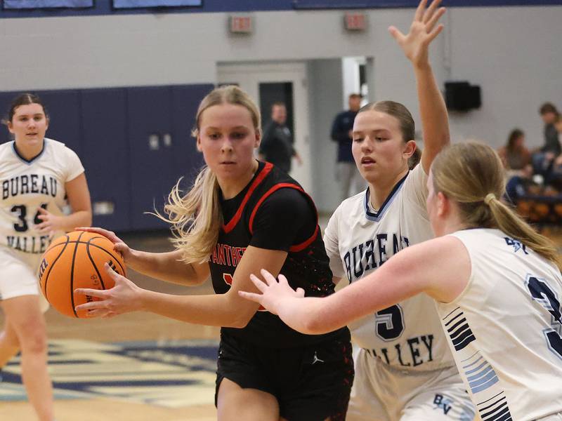 Erie-Prophetstown's Laruen Punke, works her way inside the lane as Bureau Valley defenders Emily Wright and Brooke Halms, defend during the Thanksgiving Tournament on Wednesday, Nov. 19, 2025 at Bureau Valley High School.