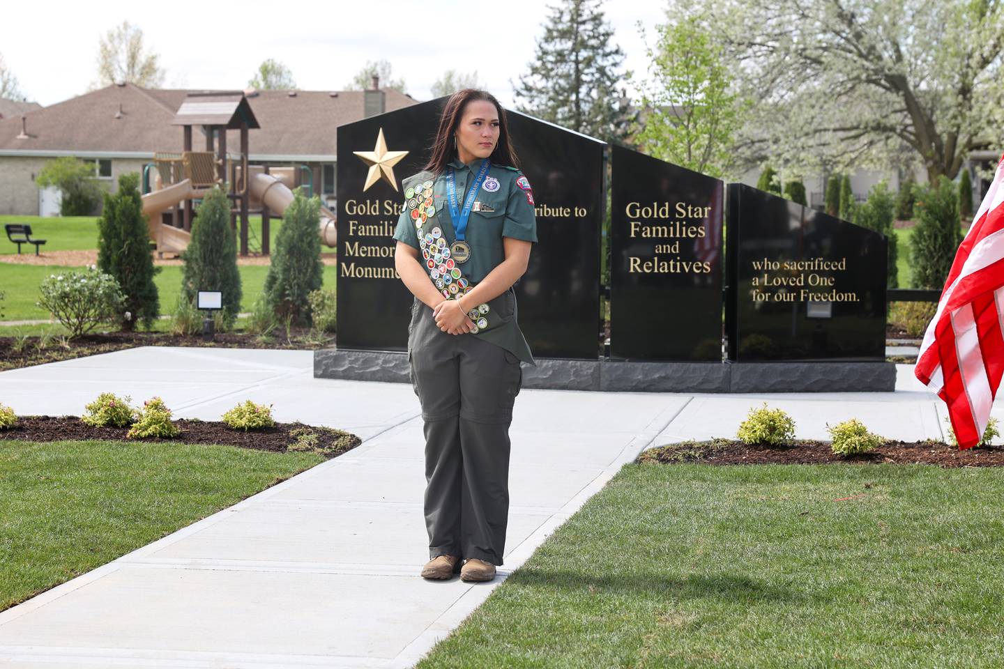 Alexis McCullough, 17, of Bourbonnais, stands in front of the new Gold Star Families Memorial Monument, which she successfully completed for her Eagle Scout project, during the dedication ceremony at Marcotte Park in Bourbonnais on Saturday, April 26, 2025.