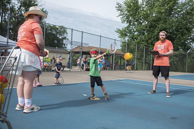 Wade Fiessinger connects with the ball while competing in the tiny tots event at the Emma Hubbs Tennis Classic Monday, July 25, 2022. The Dixon Park District will be hosting the yearly tournament all week at the Page Park tennis courts.