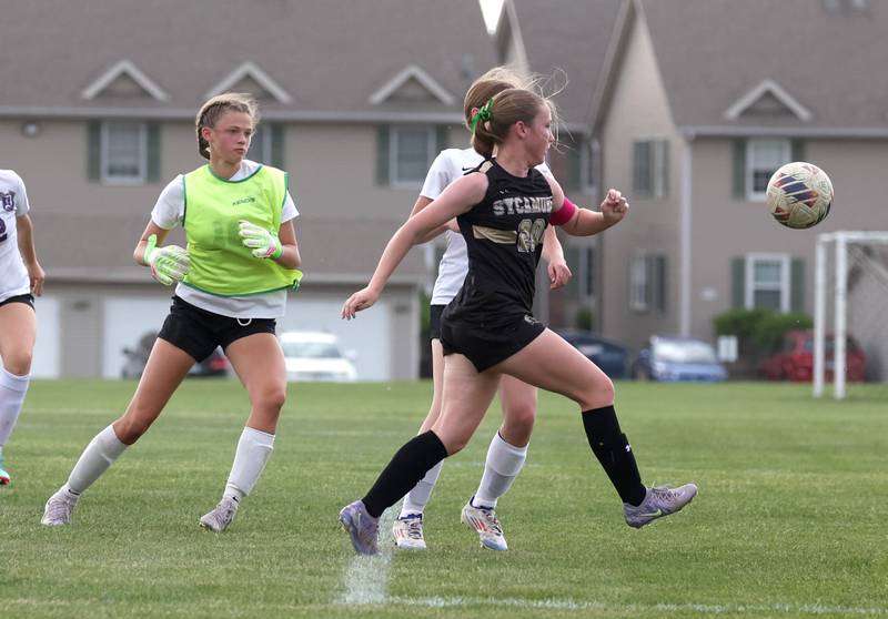 Sycamore's Cortni Kruizenga gets behind Dixon keeper Zoey Williams to score a goal during their game Thursday May 15, 2025, at Sycamore High School.
