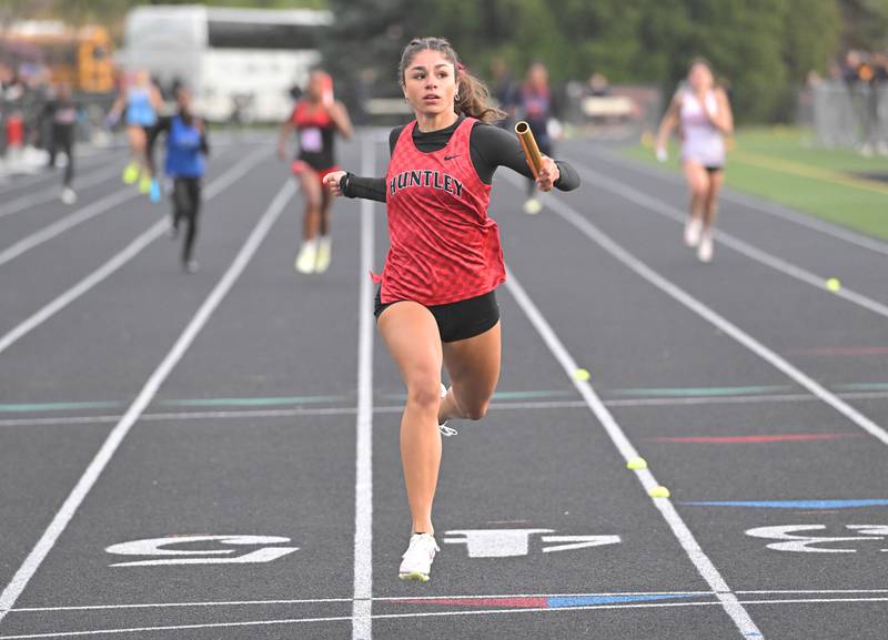 Huntley’s Victoria Evtimov anchors the 800-meter relay team to first place at the Wheaton Warrenville South Tiger Invitational girls track and field meet in Wheaton on Friday, April 26, 2024.