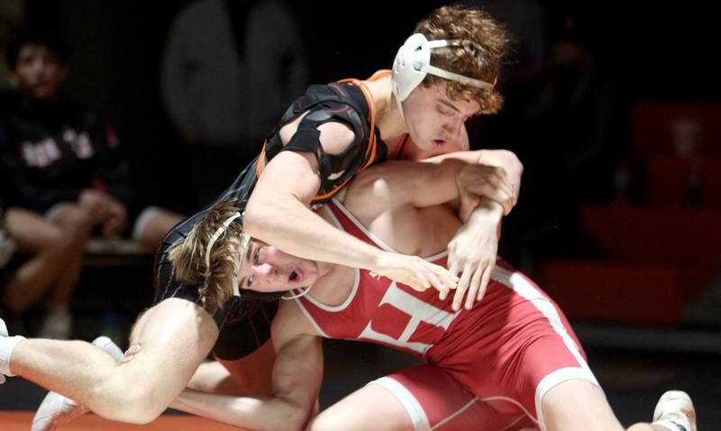 Crystal Lake Central’s Alessio Pezzella , top, battles Huntley’s Shane McGuine in a 150-pound bout in varsity wrestling at Crystal Lake Friday. Pezzella won the match.