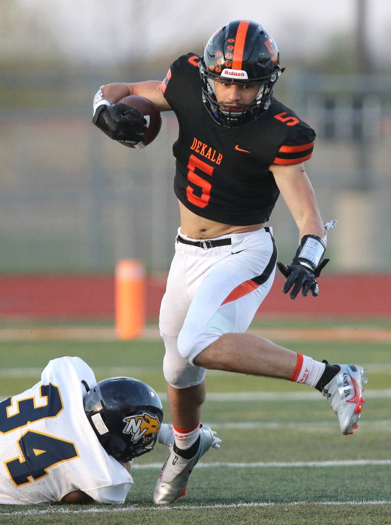 DeKalb running back Toriano Tate breaks free from a Neuqua Valley tackler during their game Friday night at DeKalb High School.