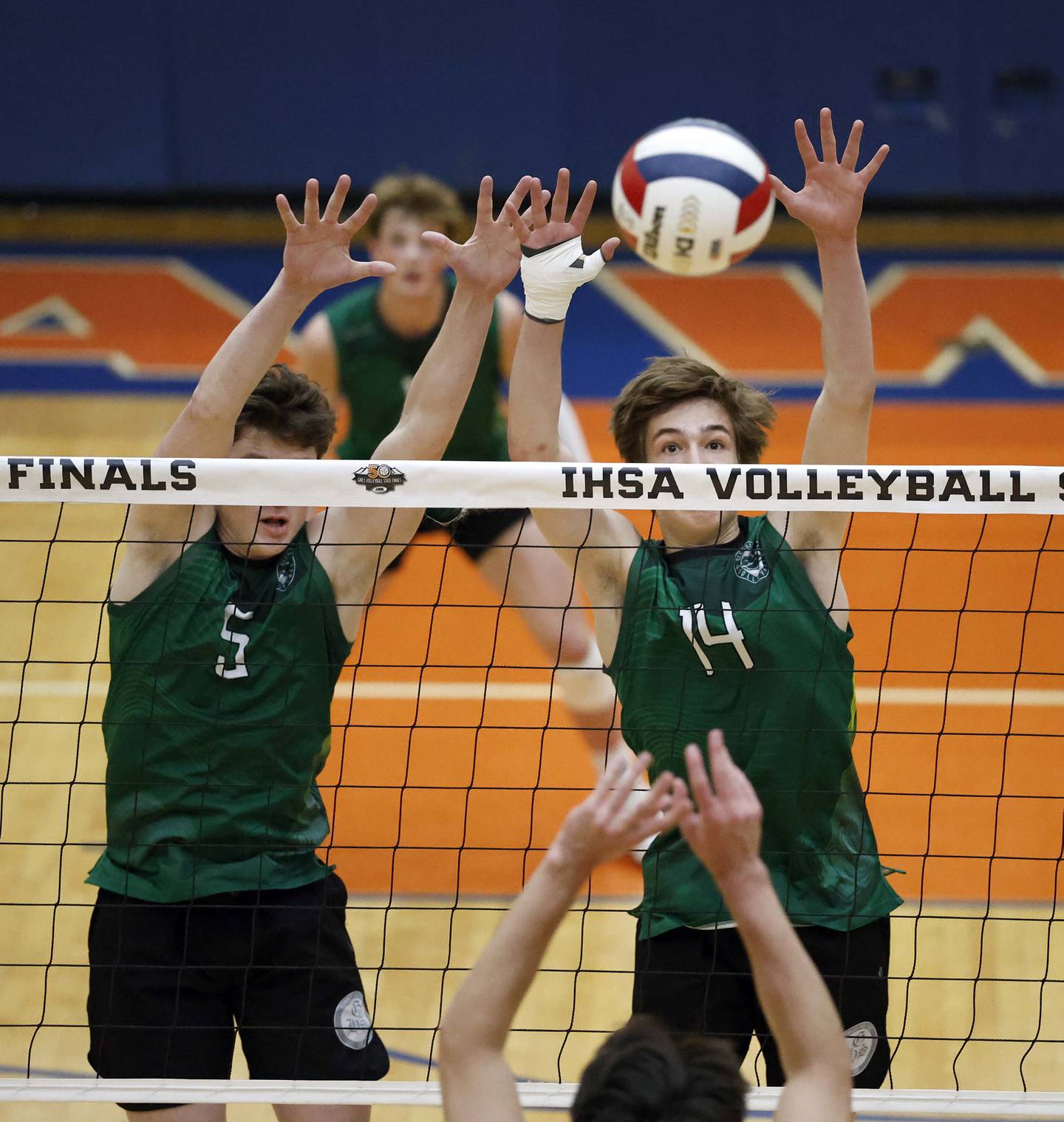 Glenbard West's Luke Bachman (5) and Ryan Gritis (14) try to block a shot by Marist during the championship match of the IHSA State Final Boys Volleyball Tournament Saturday, June 7, 2025 in Hoffman Estates.