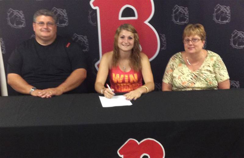 Eastland High School graduate Marissa Harris, with her parents' approval, signs a letter of intent to play softball for the Benedictine University Bulldogs in Springfield.
