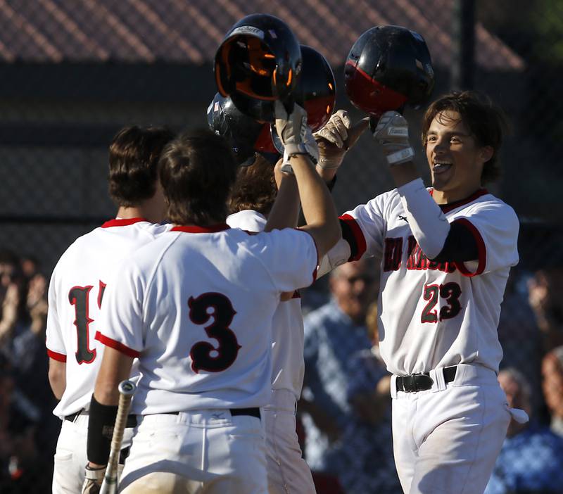 Huntley’s Chase Jetel celebrates with his teammates after hitting a grand slam home run during a IHSA Class 4A baseball sectional semi-final baseball game between Jacobs and Huntley at Jacobs High School in Algonquin.