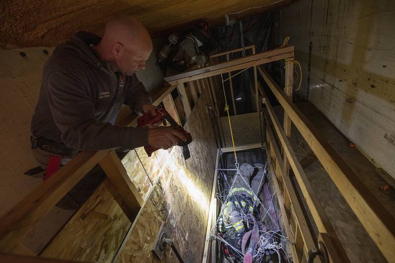 Nick Dinges instructs a cadet as he finds his way through a maze of wires Saturday, March 15, 2025, during training in Amboy.