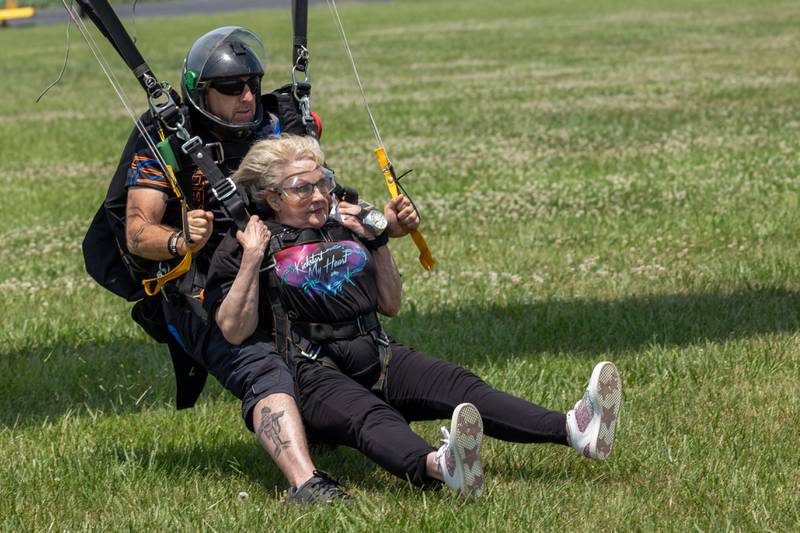 (left to right) Chad Staerkel and Kathy Traegar successfully land on ground after skydiving on Friday, July 11, 2025 at Skydive Chicago in Ottawa.