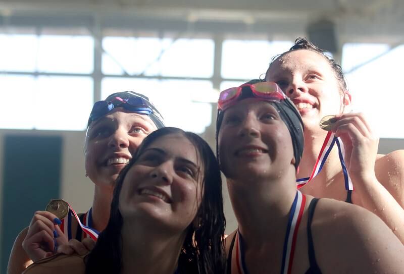 Crystal Lake South co-op’s swimmers celebrate after winning the 200-yard freestyle relay during the Fox Valley Conference Championship Meet at Woodstock North High School on Saturday, Nov. 2, 2024 in Woodstock .