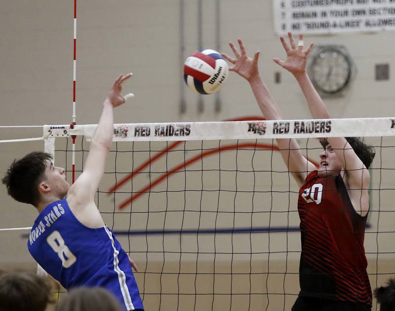 Huntley's Matthew Leith (right) tries to bloc the hit of St. Charles North's Nathan Simpson during a nonconference boys volleyball match against St. Charles North Monday, May 8, 2023, at Huntley High School.