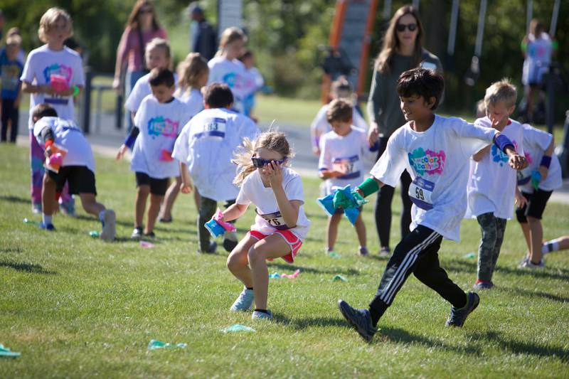 Kids gather colors prior to the Glen Ellyn 2K Kids Color Bash Run on Saturday Aug.10, 2024 at Ackerman Park in Glen Ellyn.