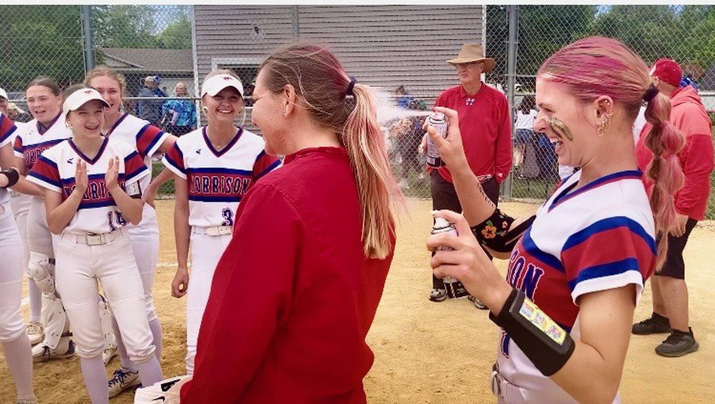 Morrison pitcher Bella Duncan gives head coach Chelsea Eads a spray of pink hair to celebrate the Fillies' 9-0 regional championship win at Princeton on Saturday.