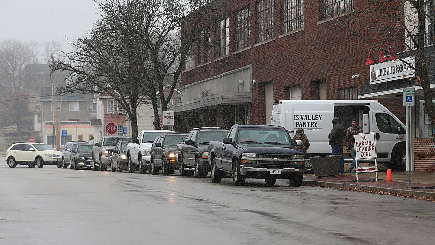 A long line of cars wait for food from the Illinois Valley Food Pantry on Wednesday, Nov. 16, 2022 in La Salle.