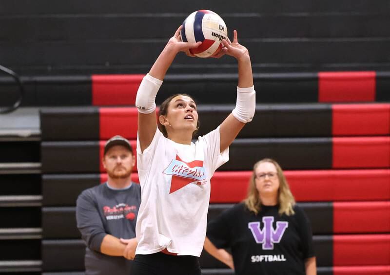 Indian Creek’s Izzy Turner sets the ball as her coaches look on during practice Tuesday, Aug. 13, 2024, at the school in Shabbona.
