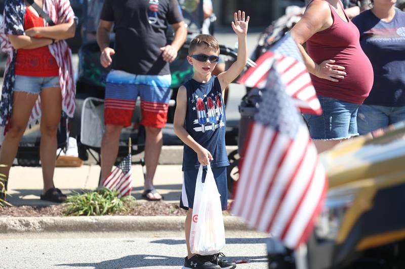 Caden Evans, 7-years old, waves to a vehicle driving in the Manhattan Labor Day Parade on Monday, Sept. 4, 2023 in Manhattan.