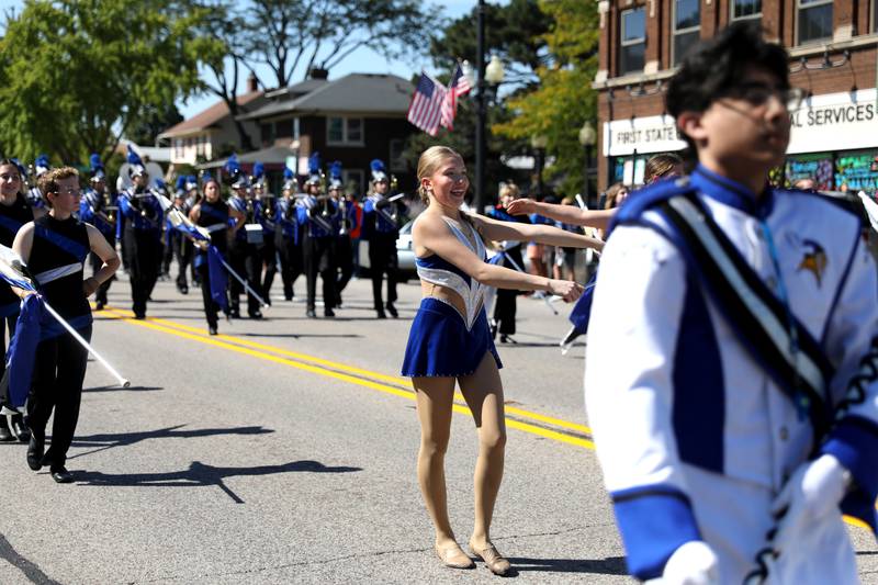 Geneva High School baton twirlers lead the marching band during the school’s annual homecoming parade on State Street on Friday, Sept. 15, 2023.