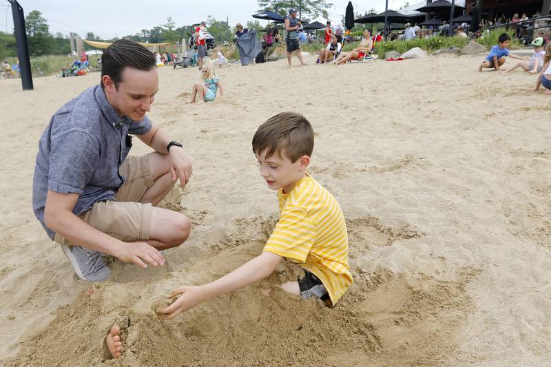 Nick Branson of Cary and son, Ben, 9, play in the sand during a Beers, Burgers, Brats and Bands event for Father's Day at the Quarry Cable Park on Sunday, June 20, 2021, in Crystal Lake.