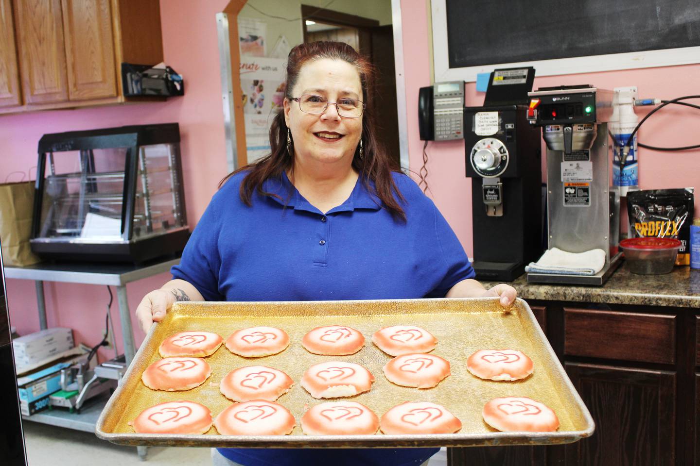 As each day goes on, Folsom's Bakery owner Jim Helle's staff continues the work he begins in the wee hours of the morning, both in the kitchen and at the front counter. Lisa Hughes (holding tray) works in both settings, serving customers their favorite treats from the cases, and designing creative cookies that also appeal to their eyes. "I get the be creative on the cookies," Hughes said. "For Valentine's Day, I could do all of the hearts I want. When it comes to the holidays, I can get some good designs and go wild on them. I like to see people's faces when they come in and go, 'Those are real nice!'"