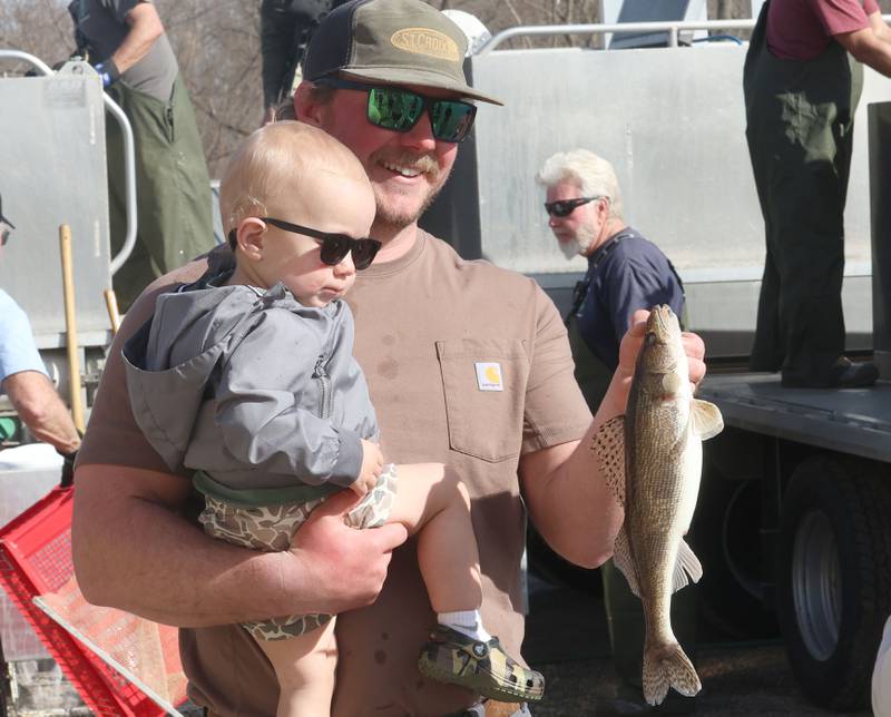 Kyle Horner of Streator, smiles for a photo with his son Oats while holding a walleye during the annual Masters Walleye Circuit tournament on Friday, March 20, 2026 at the Spring Valley Boat Club.