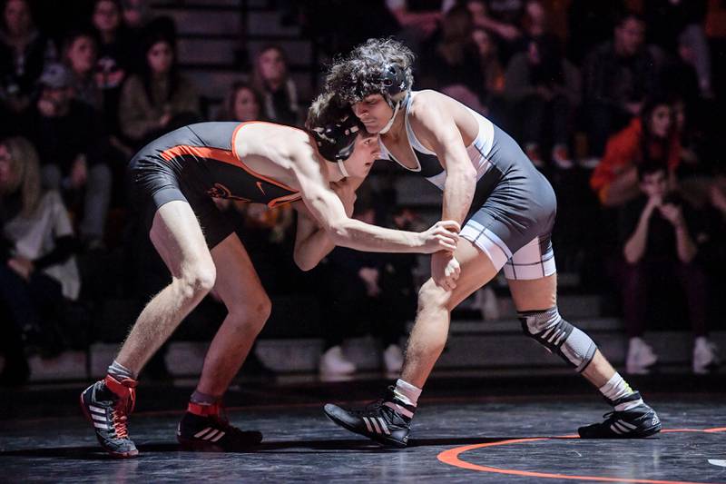 St. Charles East’s Liam Aye and Marian Central’s Anthony Alanis wrestle at 120 pounds during a match in St. Charles on Wednesday, December 20, 2023.