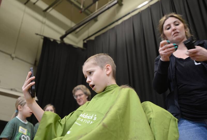 Forest Road 6th grader Finn Long reacts while participating in the St. Baldrick fundraiser Thursday, March 7, 2024.