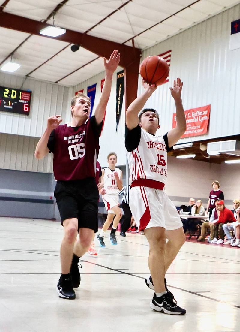 Princeton Christian Academy's Michael Glass shoots in front of Ottawa Christian Academy's Joseph Jameson Tuesday at Howard Hoffman Memorial Gym. The Eagles won 57-42.