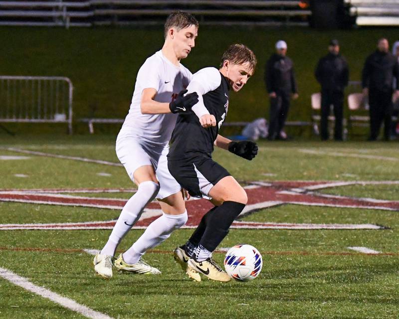 Prairie Ridge's Jensen Schroeder, right, and Benet Academy's Ruslan Holubec (17) battle for the ball during the class 2A super sectional soccer match on Tuesday Nov. 5, 2024, held at Wheaton Academy in West Chicago.