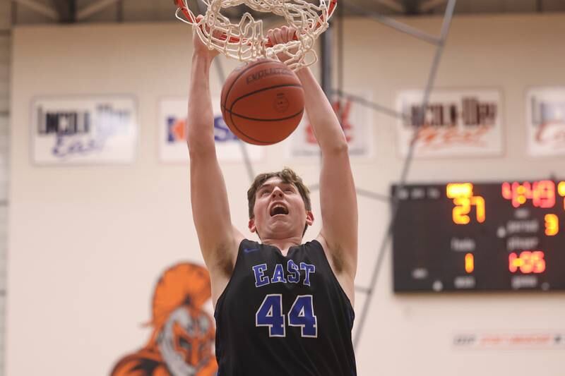 Lincoln-Way East’s Mac Hagemaster throws down a dunk against Lincoln-Way West.