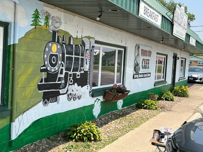 Terri Ellinger of Wilmington is painting a mural on the exterior of The Whistle Stop Cafe in Diamond, a restaurant where Ellinger frequently stops for a homemade meal.