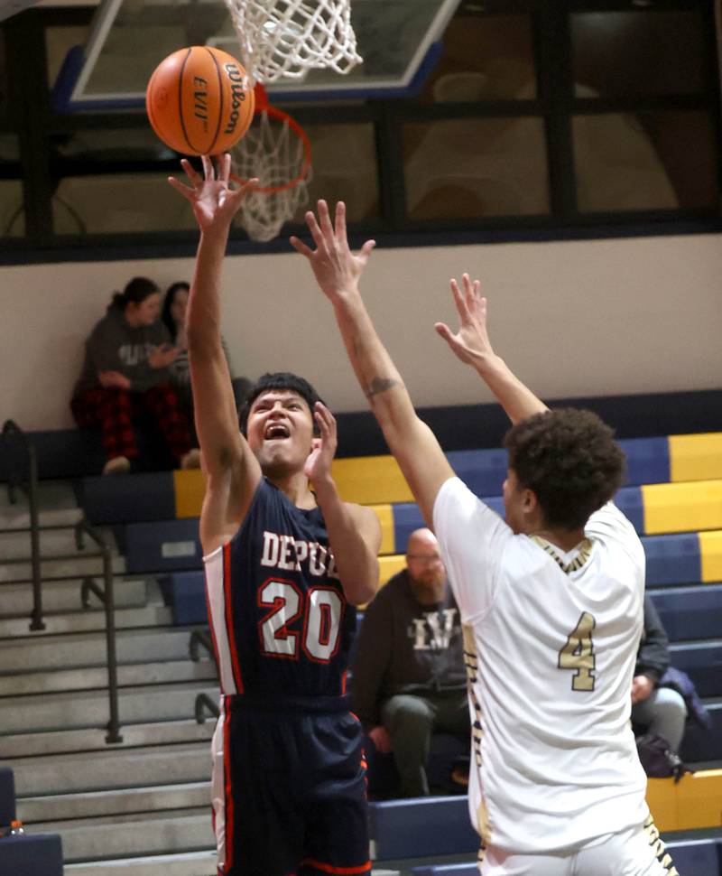 DePue’s Nico Lopez shoots over Hiawatha's Elijah Beaver during their game Tuesday, Jan. 20, 2026, at Hiawatha High School in Kirkland.