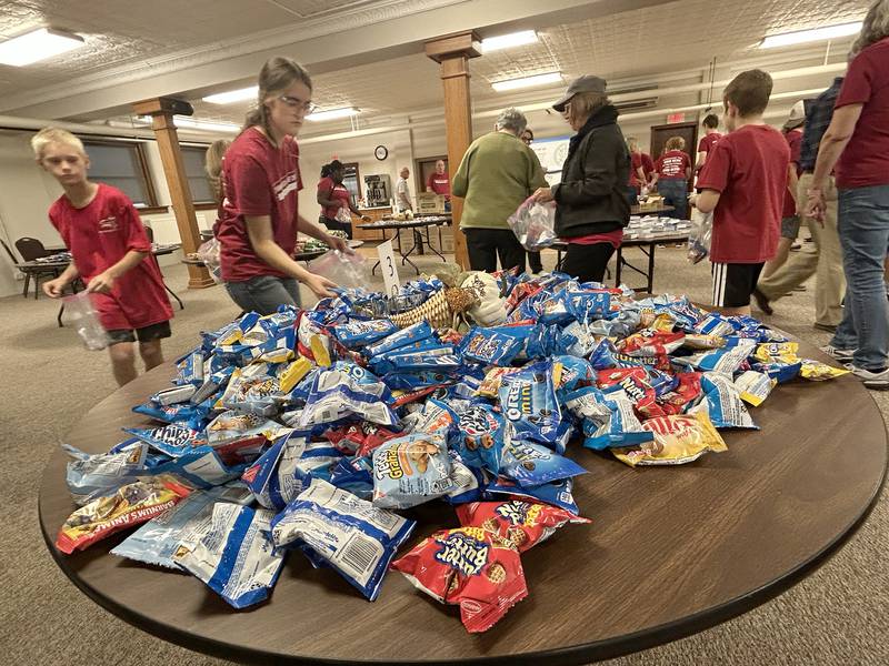Volunteers assembled care packages for sailors on the USS Fitzgerald at the Evangelical Free Church of Mt. Morris  on Thursday, Oct. 16, 2025.