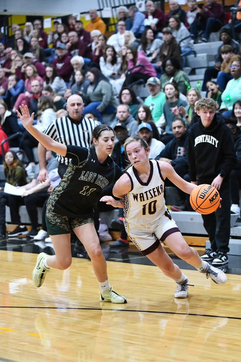 Bishop McNamara's Trinity Davis defends a drive by Watseka-Milford's Christa Holohan during the Fightin' Irish's 69-38 victory over Watseka-Milford in the IHSA Class 2A Herscher Sectional championship on Thursday, Feb. 27.