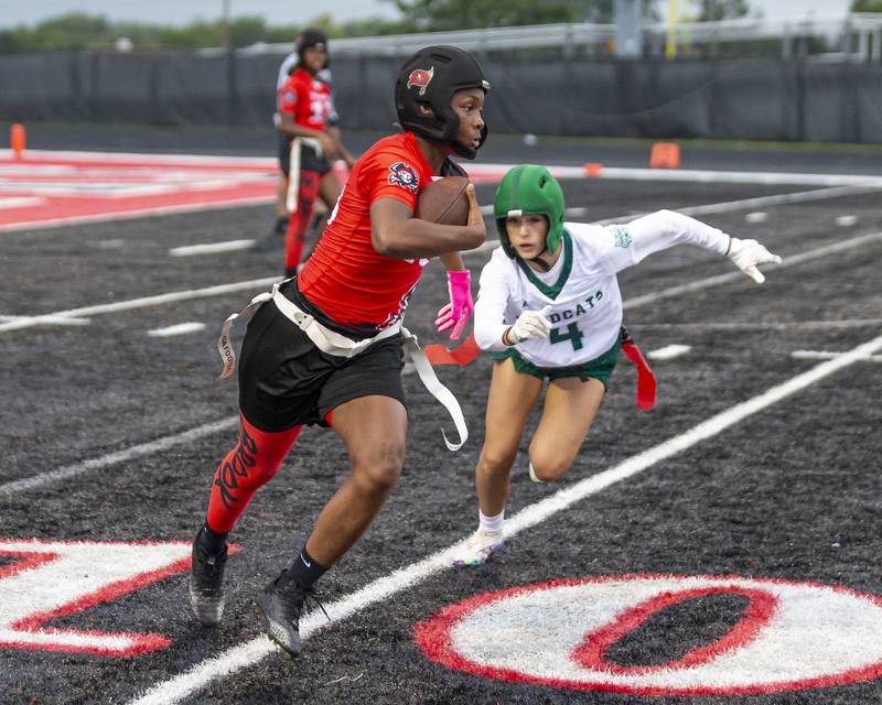 Bolingbrook's (18) runs with the ball with Plainfield Central's Alyssa Page (4) in pursuit during flag football game between Plainfield Central at Bolingbrook Wednesday, Sept 3, 2025  in Bolingbrook.