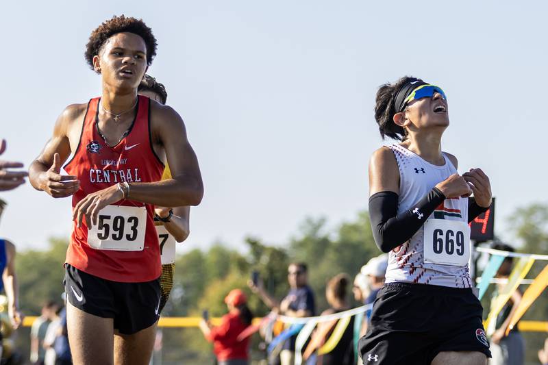 Lincoln-Way Central’s Mekhai Wright and Plainfield East’s John Berducido cross the finish line during the Locktoberfest three-mile varsity cross country race at Dellwood Park in Lockport on October. 4, 2025.