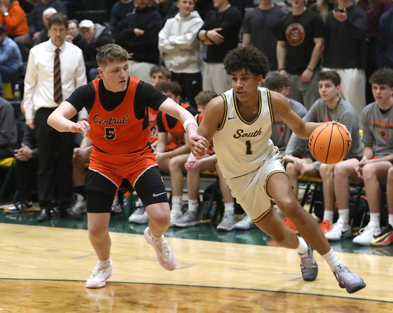 Crystal Lake Central's Sonny Shanahan (right) drives to the basket against Crystal Lake Central's JR Mason during an IHSA Class 3A Crystal Lake South Regional boys basketball semifinal game on Wednesday, February, 25, 2026, at Crystal Lake South High School.