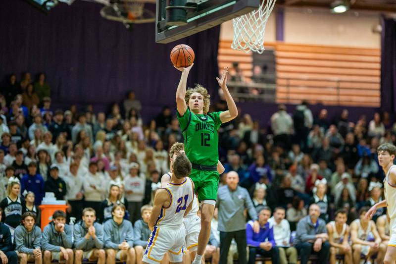 York's Brendan Molis (12) shoots the ball on the baseline against Downers Grove North's Jack Stanton (21) during a basketball game at Downers Grove North High School on Friday, Dec 9, 2022.
