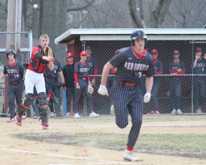 Streator catcher Joe Hoekstra throws to first base to force out Hall's Jack Jablonski on Tuesday, March 18, 2025 in Foley Field at Kirby Park in Spring Valley.