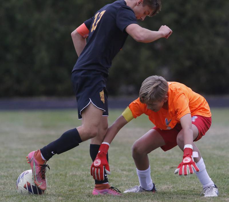 Richmond-Burton's Joseph Kyes kicks the ball away from Marian Central' goal keeper Dustin Emmert during the IHSA Class 1A Marian Central Regional Boys Soccer Final match on Tuesday, Oct. 22, 2024, at Marian Central High School in Woodstock.