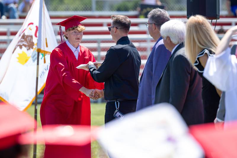 Izzaq Zrust receives diploma from father Zaq Zrust on Sunday, May 18, 2025 at Hall High School in Spring Valley.