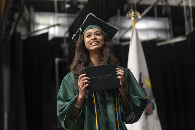 Brenna Lynn Burlack shows off her diploma to loved ones Sunday, May 17, 2026, at Rock Falls High School’s commencement of the class of 2026.