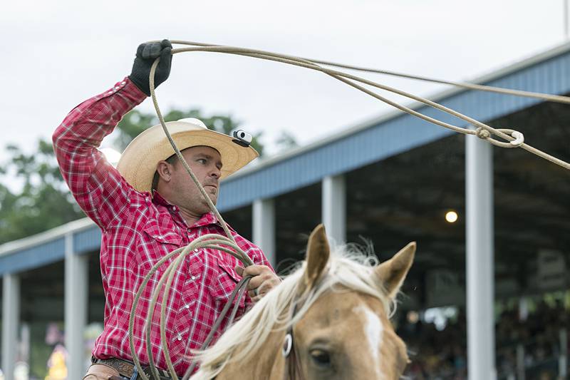 A cowboy shows off his roping skills during the opening ceremonies of the Next Level Pro Bronc Riding rodeo Wednesday, Aug. 14, 2024, at the Whiteside County Fair in Morrison.